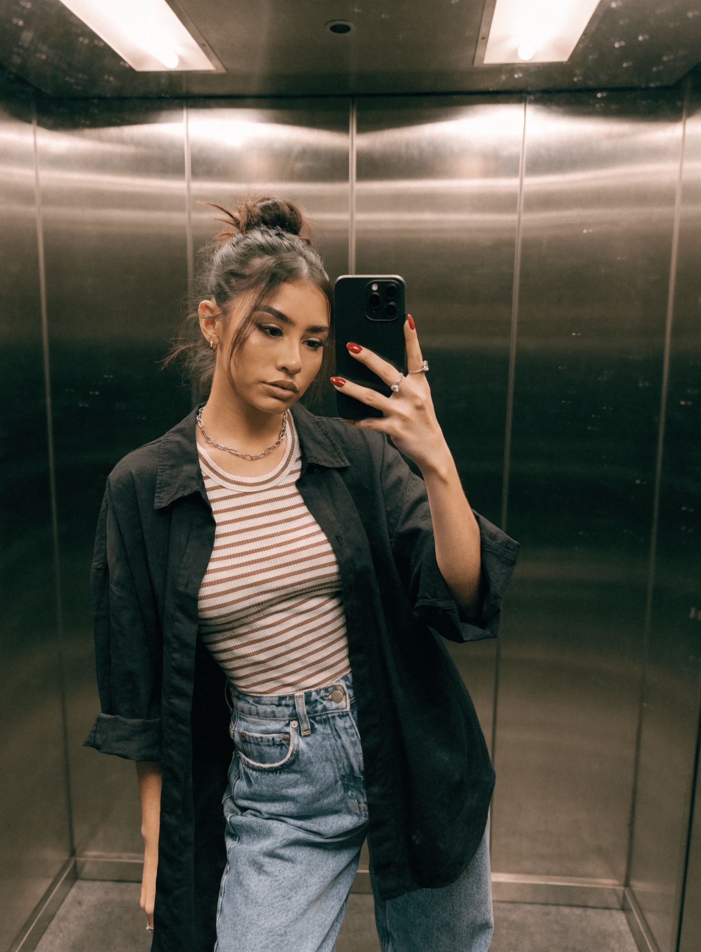 UGC-style mirror selfie of a fashionable woman